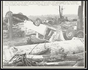 An automobile, picked up and blown off Highway 80 by tornadic winds 2/21 lies in the midst of the tangle of machinery and corrugated metal buildings in this rural agricultural community. Six died in this community and three are still missing following the tornados.