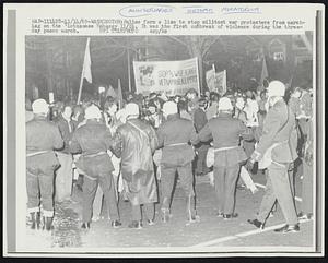 Police form a line to stop militant war protesters from marching on the Vietnamese Embassy 11/14. It was the first outbreak of violence during the three-day peace march.