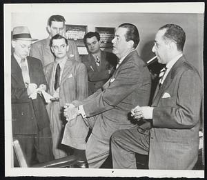 Bob Bows Out- Robert E. Hannegan (second from right), former postmaster general, discusses the details of his sale of the St. Louis Cardinals to his partner Fred M. Saigh, Jr. (right). Saigh is now president and majority stockholder of the club and it's extensive farm system.