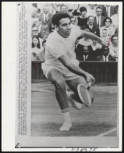 Wins Wimbledon Title--Manuel Santana of Spain is shown in action as he defeated Dennis Ralston of Bakersfield, Calif., for the singles title in the All-England tennis championships at Wimbledon, England, today. Santana, who is the United States champion, won in straight sets, 6-4, 11-9,6-4.