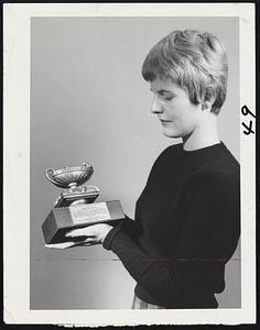 Coveted Award, the Lamp of Knowledge of the New England chapter, Public Relations Society of America, will be presented Thursday night at the Algonquin Club to Robert M. Jenney, president of the Jenny Mfg. Cp. Miss Nancy Hearn reads inscription.