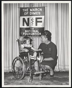 March of Dimes volunteer, mrs. Arthur S. Hotch of Boston and Littleton Common, shown with Mary Lou Graves, 5, Flint, Michigan, 1964 National March of Dimes Girl, victim of birth defect known as open spine. They recently attended a planning meeting at New York City for the campaign to be held January 2 through 31 to fight birth defects and arthritis. Mrs. Hotch serves as State Advisor on Women's activities for the National Foundation-March of Dimes which is the largest single national source of private support for research and patient care in these two disease areas.