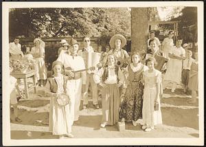 Costumed men, women, and children at street fair