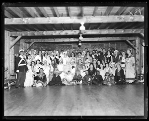 Group in costume pose in barn.