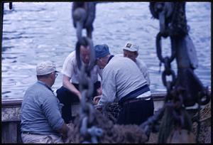 Fisherman mending nets
