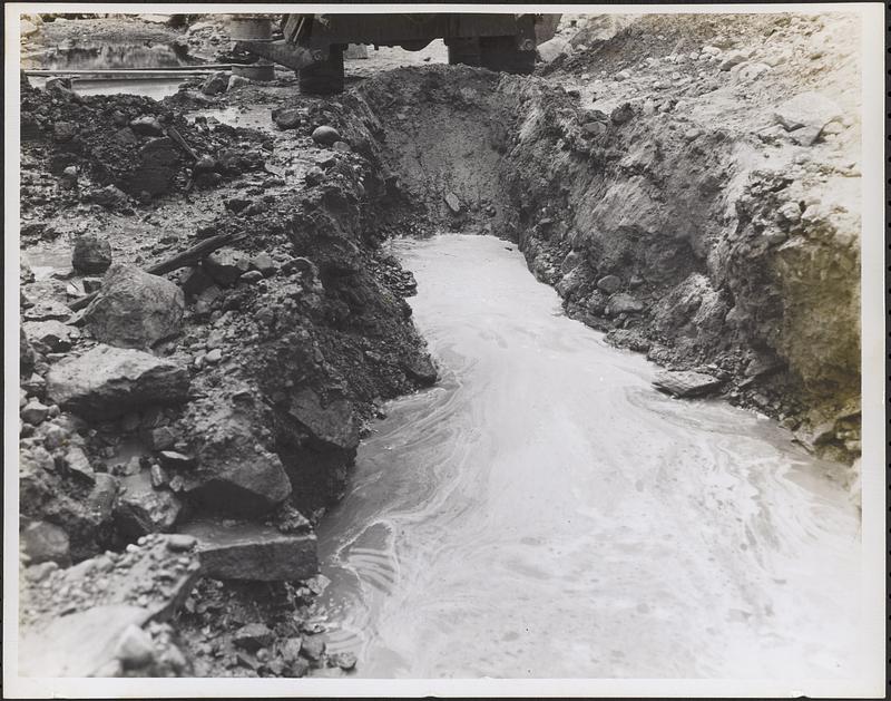 Test pit 4 showing water and gravel looking east