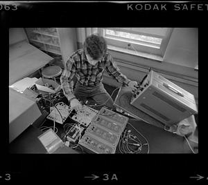 Man adjusts electronic equipment