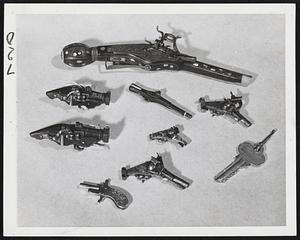 These Guns Go "Pip!"-Miniature pistols owned by Robert Abels, New York gunsmith, are shown alongside a common house key for size comparison. They're tiny but terrific.