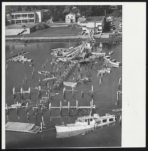 Port Edgewood in Cranston, R.I., looked like this today after being smashed hard by Hurricane Donna. Finger piers were ripped apart and several large boats sank at their moorings. The large white boat in the foreground, "The Ardea," belongs to B. A. Dario, managing director of Lincoln Downs Race Track.