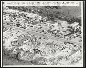 Huntington, Tenn.: An aerial view traces the path of a tornado that slashed through a portion of the business district here 5/7 night. Thirteen businesses were leveled by the twister.