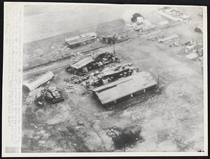 Typhoon Damage on Iwo Jima--A typhoon sweeping over Iwo Jima, scene of one of the Pacific war's bloodiest battles, leveled 85 per cent of the island's fixed installations, Aug. 22. Here are some damaged quonset huts and warehouses.