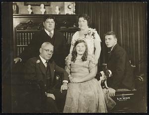 Former Mayor Malcolm E. Nichols and his family. At the right of Mrs. Nichols is Dexter Nichols and at her left is Clark Nichols while Miss Marjorie Nichols is in the foreground.