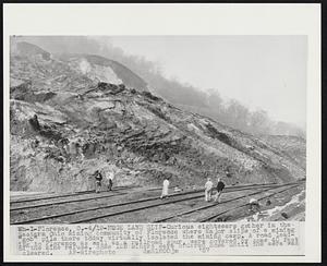 Huge Land Slip-Curious sightseers gather in the Eastern Ohio mining community of Florence where major slips of a mining "gob" pile there today virtually isolated the mining camp. A road leading to Florence as well as a railroad spur, were covered by some 40 feet of the mine refuse. Some 125 miners were ordered home until the aera was cleared.