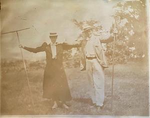 Mabel Simpkins and unidentified man holding cranberry rakes in Yarmouth Port, Mass.