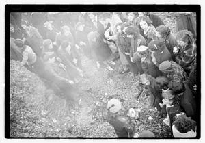 A group of young women cooking food on a fire
