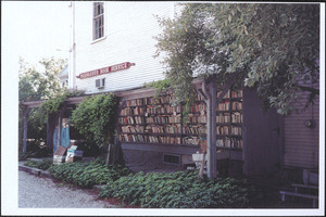 Outside wall on the side of the Parnassus Book Service next to the parking lot, with book shelves, 220 Old King's Highway, Yarmouth Port, Mass.