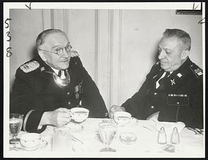 Old And New Commanders-Capt. Albert E. Roberts (left), retiring commander of the Ancient and Honorable Artillery Company, is shown above in conference with his successor, Lt. Louis Charles Adams, elected at a drum head ceremony on Boston Common today.