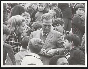 Mayor White and his wife, Kathryn, autograph programs for Boston Park Department youngsters.