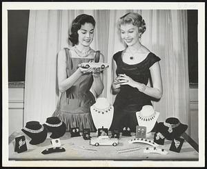 Diamonds may be a girl's best friend, but Models Mary Gardiner and Sandy Rosten appear more interested in the miniature Buick Mary is holding. The $3,000,000 collection of gems, including the famed Hope diamond worn by Miss Rosten, is displayed by Buick at the General Motors Motorama.