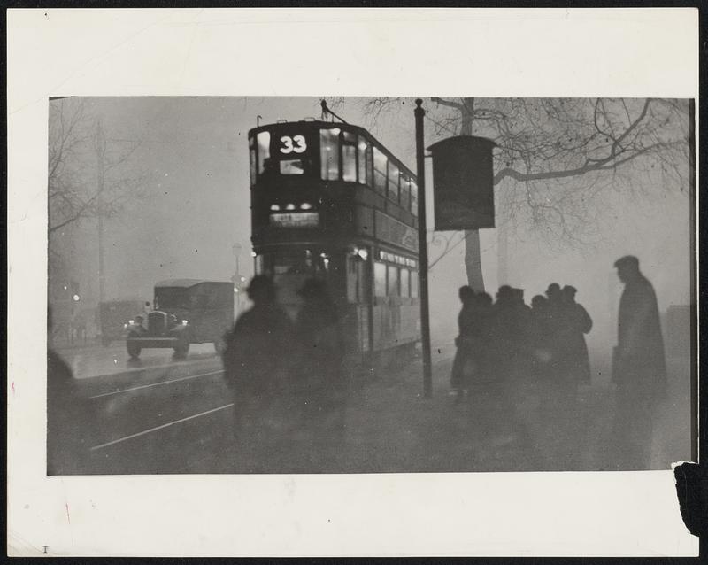 This Eerie Scene is on the embankment at Charing Cross on an early morning recently as a dense fog settled over London. It was so dense that one bus took three hours to cover its regular 15-minute run.