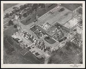 Where 649-Foot TV Tower Fell on roof of WBZ building on Soldiers Field road, Allston. In the center can be seen where a section of the hurricane-felled structure crashed into the second floor, barely missing several employes. Note the tip of the tower lying across the trotting track at the upper left corner.