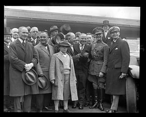 A group of unidentified people, some in military uniform, posing