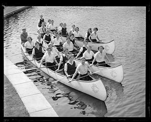 LaSalle college girls in their war canoes, Charles River, Auburndale