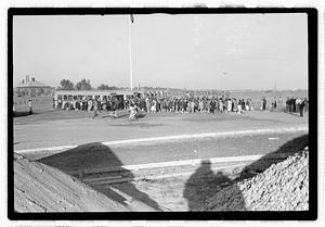 A crowd of people gathered by buses