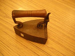 Metal flat iron with wooden handle