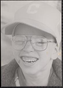 Closeup of boy wearing a baseball cap and glasses