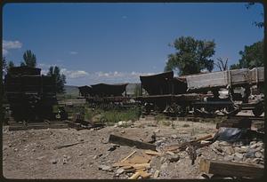 Debris around old train cars, likely Nevada City, Montana
