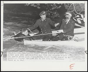 'Flood Victim Rescued' Toronto lifesavers pull this unidentified man from the swollen waters of the Humber river last night. Rising flood waters caused by hurricane 'Hazel' trapped him in his car.