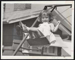 National Foundation's 1961 poster girl is Linda Breeze, 4, of Columbus, Ohio. When she gets off the swing she needs crutches to get around. She was born with an open spine and represents millions of handicapped children.