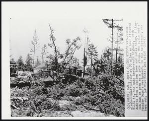 Glen, N.H. – The Wind’s Way – Winds clocked unofficially at 70 miles an hour littered route 16, the main north-south highway, with debris from a fallen tree and poles today. A lineman can be seen on a pole stump. The gable end of Stanley Duza’s restaurant, in the background, was torn out.