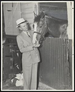 Earl Sande, considered one of the greatest jockeys of his time and now the successful trainer of Col. Maxwell Howard's racing string, is shown talking over with The Chief, one of Howard's two great 3-year-olds, after detraining at Narragansett Park yesterday. The Chief and Stagehand checked in yesterday for the $10,000 Thornton Memorial 'Cap on Saturday and for the $25,000 Gansett Special to be run a week later. The Chief is best known for his wins in the Brooklyn and Dwyer Handicaps in New York this year; Stagehand for his win over Seabiscuit in the Santa Anita Handicap. Both are 3-year-olds. Sande has been in New England before but not since he became a big time trainer.