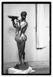 Statue holding a tray