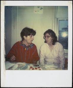 Two people sitting and talking