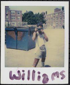 Young man taking photos in Newtowne Court