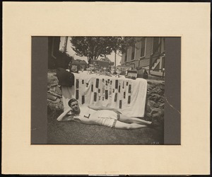 Man reclining in front of awards