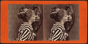 Woman kissing her reflection in the looking glass