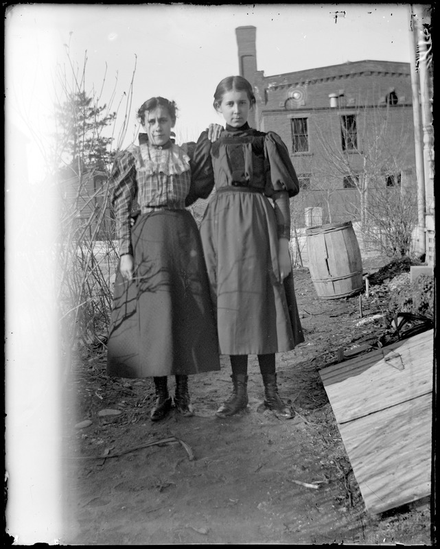 Two young women in yard