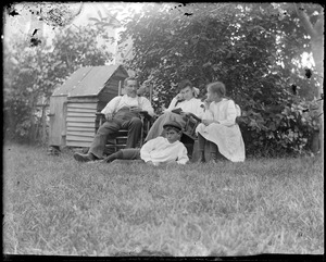 C.R. Wilhelm and three children in a yard