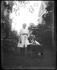 C.R. Wilhelm and his daughter in their yard