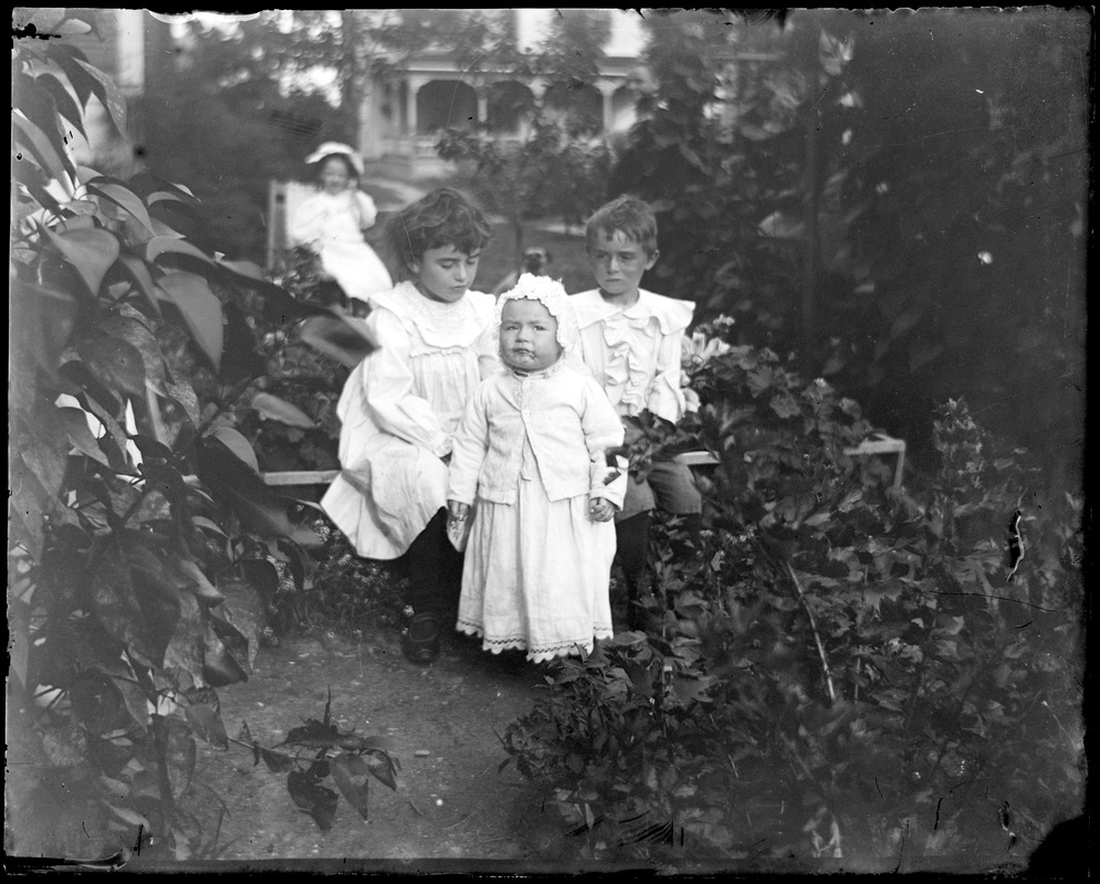 Erna, Fredrick, and Mabel Wilhelm in a garden