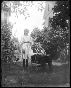 C.R. Wilhelm and his daughter Mabel in their backyard