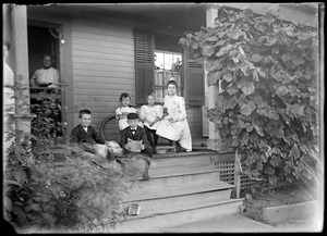 Children and two women on a porch
