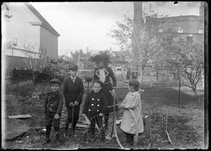 Four Wilhelm children and a boy in the Wilhelm's back yard