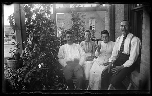 Two couples on a tenement porch