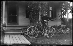 Robert Wilhelm standing with a bicycle and a dog