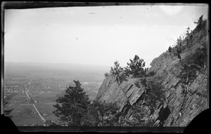 A man and woman sitting on the cliffs of Mount Tom